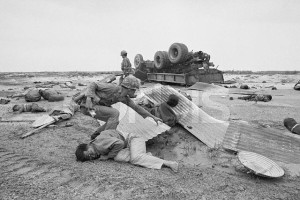 28 Apr 1972, Outside Quang Tri City, South Vietnam --- Outside Quang Tri City, So. Vietnam: An ARVN tries to extricate wounded civilians from debris after truck loaded with refugees struck a mine four miles south of Quang Tri. At least 40 persons were killed and 60 injured in the incident involving three different vehicles. --- Image by © Bettmann/CORBIS